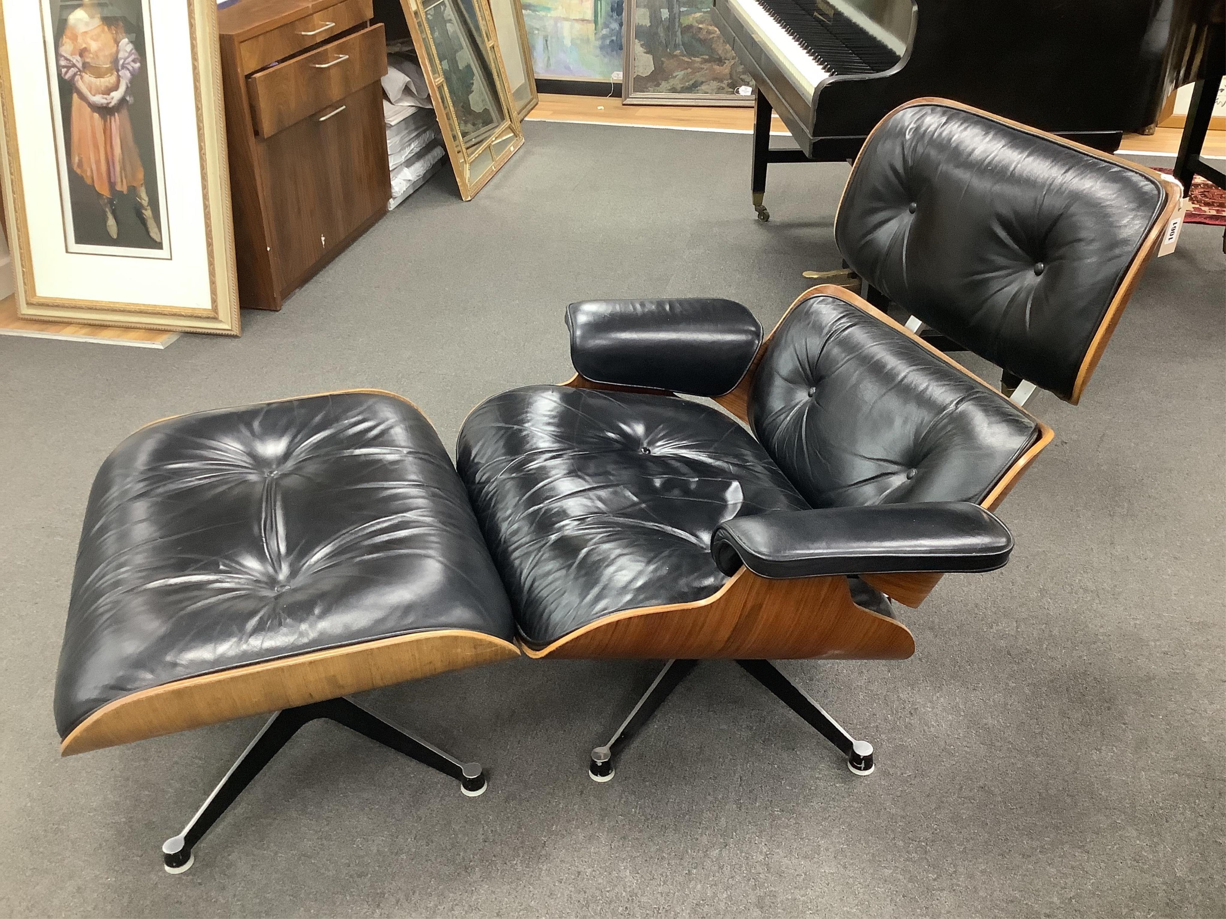 Charles and Ray Eames, a model 670 black leather and Indian rosewood lounge chair, width 85cm, depth 80cm, height 80cm, and a 671 ottoman, manufactured by Hille, London Ltd. Condition - fair to good